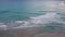 Unobstructed horizon on beach, ocean meets the sky in an uninterrupted line.