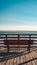 Unoccupied bench offers serene ocean view on pier