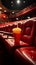 Unoccupied red seats, popcorn, and drinks strewn across the theater floor