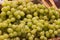 Unpacked white seedless grapes in basket on display in organic super market