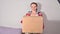 Unpacking the parcel. A woman holds a large paper box in her hands, a parcel. Successful Mailing Concept , service for