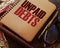 Unpaid debts words on copybook, glasses, pen. Financial obligations concept