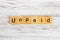 UNPAID word made with wooden blocks concept