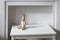 unpainted wooden hare on hinges is on a white table in front of a fake fireplace. Place for text
