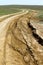 Unpaved broken dry dirt country road in steppe, offroad drive