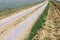 Unpaved dry dirt country road in steppe, offroad drive