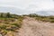 Unpaved gravel road going up the hill