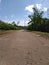 an unpaved path in a small village