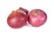 Unpeeled whole red onion, shallots on white