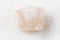 unpolished pink Fluorite rock on white marble