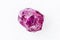 Unpolished Rhodolite pyrope crystal on white