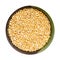 Unpolished yellow proso millet in bowl isolated