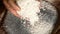 Unprocessed rice being poured from a man\'s hands