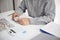 Unrecognisable businessman, accountant, banker counting money at the workplace, white background.