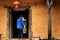 Unrecognisable hmong farmer entering a traditional hmong house with a chinese lantern hanging in Ha Giang Province, Vietnam