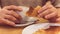 Unrecognisable man having breakfast, eating fresh pastry, with copy space