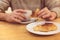 Unrecognisable man having breakfast, eating fresh pastry, with copy space