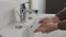 Unrecognisable man washing hands