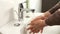 Unrecognisable man washing hands