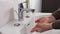 Unrecognisable person washing hands