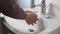 Unrecognisable person washing hands
