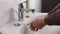 Unrecognisable person washing hands