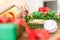 Unrecognisable woman making christmas wreath in living room. DIY Christmas decoration concept. Hands close up.