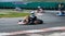 Unrecognised man driving Go-kart with speed in the on a karting track