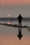 Unrecognised person standing and enjoying the sunset at a lake. Larnaca Cyprus