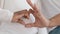 Unrecognizable African American couple afro black ethnic future parents woman and man make heart shape with fingers show