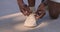 Unrecognizable african american sportsman fixing his sneakers during exercising, close up