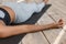 Unrecognizable african woman lying on yoga mat in corpse pose, cropped image