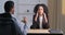 Unrecognizable afro american businessman sits at table with businesswoman reads document contract report statement of