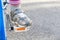 Unrecognizable anonymous child`s foot resting on a bicycle pedal, object closeup, little young kid cyclist riding a bike