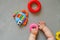 Unrecognizable baby playing with developing toys. Baby hands and toys. Overhead view.