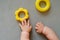 Unrecognizable baby playing with developing toys. Cute baby`s hands and plastic toys. Overhead view.