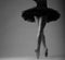 Unrecognizable ballerina in studio, black tutu outfit. long legs, black and white image