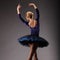 Unrecognizable ballerina in studio, blue tutu outfit. view from the back