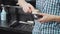 Unrecognizable barber cleaning his electric clipper after working