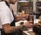 Unrecognizable Barista Making Coffee Working In Cafe Indoor, Cropped