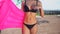 Unrecognizable beautiful young bikini woman with perfect fit body holding pink mattress. Weight loss and body image