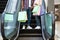 Unrecognizable Black Couple Riding Down Escalator With Lots Shopping Bags In Hands