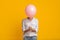 Unrecognizable Black Girl Hiding Face Behind Pink Balloon