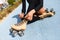 Unrecognizable black girl sitting on bike line and puts on skate