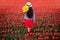 Unrecognizable blogger standing in blooming field during tulip season