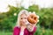 Unrecognizable blond woman holding rotten apple in her hand