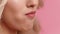 Unrecognizable Blonde Woman Eating Strawberry Over Pink Studio Background, Closeup