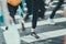 Unrecognizable and blurry people walk along the pedestrian crossing in the city in summer