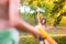 Unrecognizable boy splashing girl with water gun, sunny summer