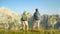 Unrecognizable carefree hiker couple observes the idyllic mountains on sunny day